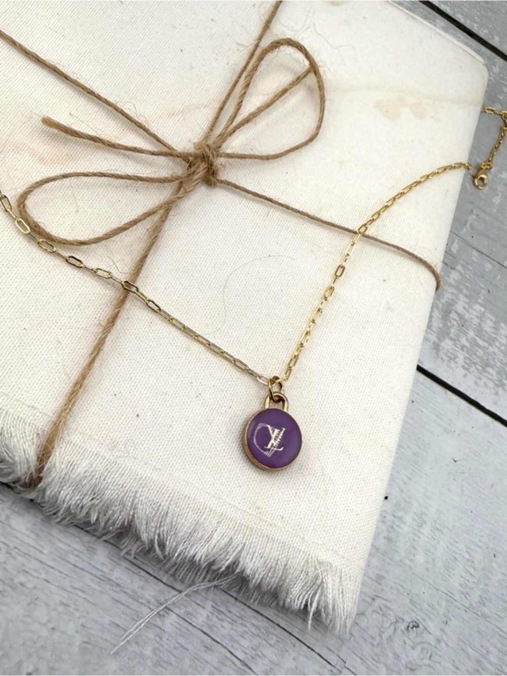 Repurposed necklace with Louis Vuitton round purple zipper pull.